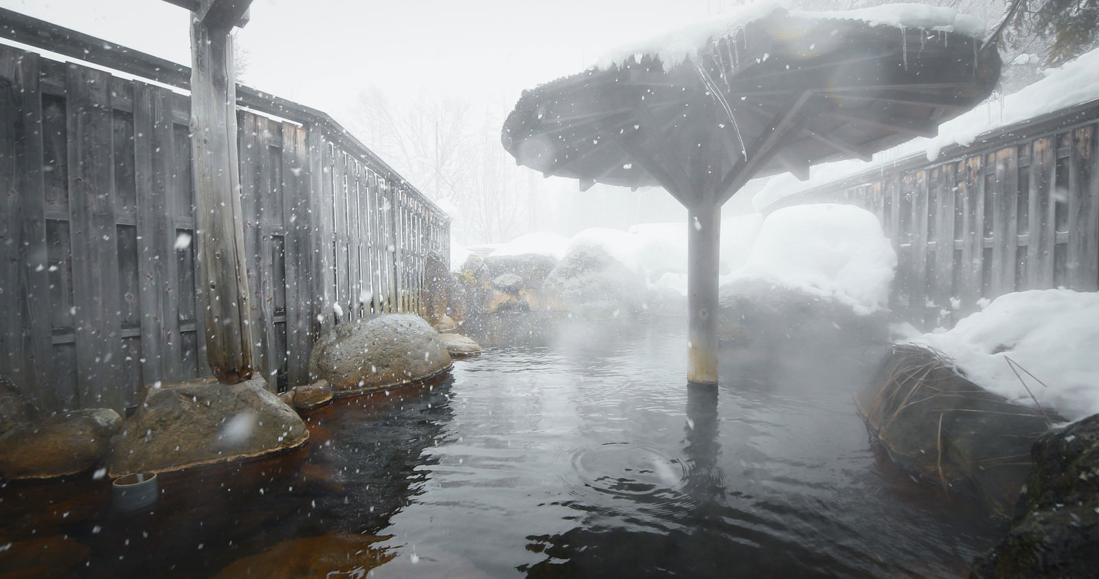 「雪が舞う露天風呂（平湯プリンスホテル） | フリー素材のぱくたそ」の写真