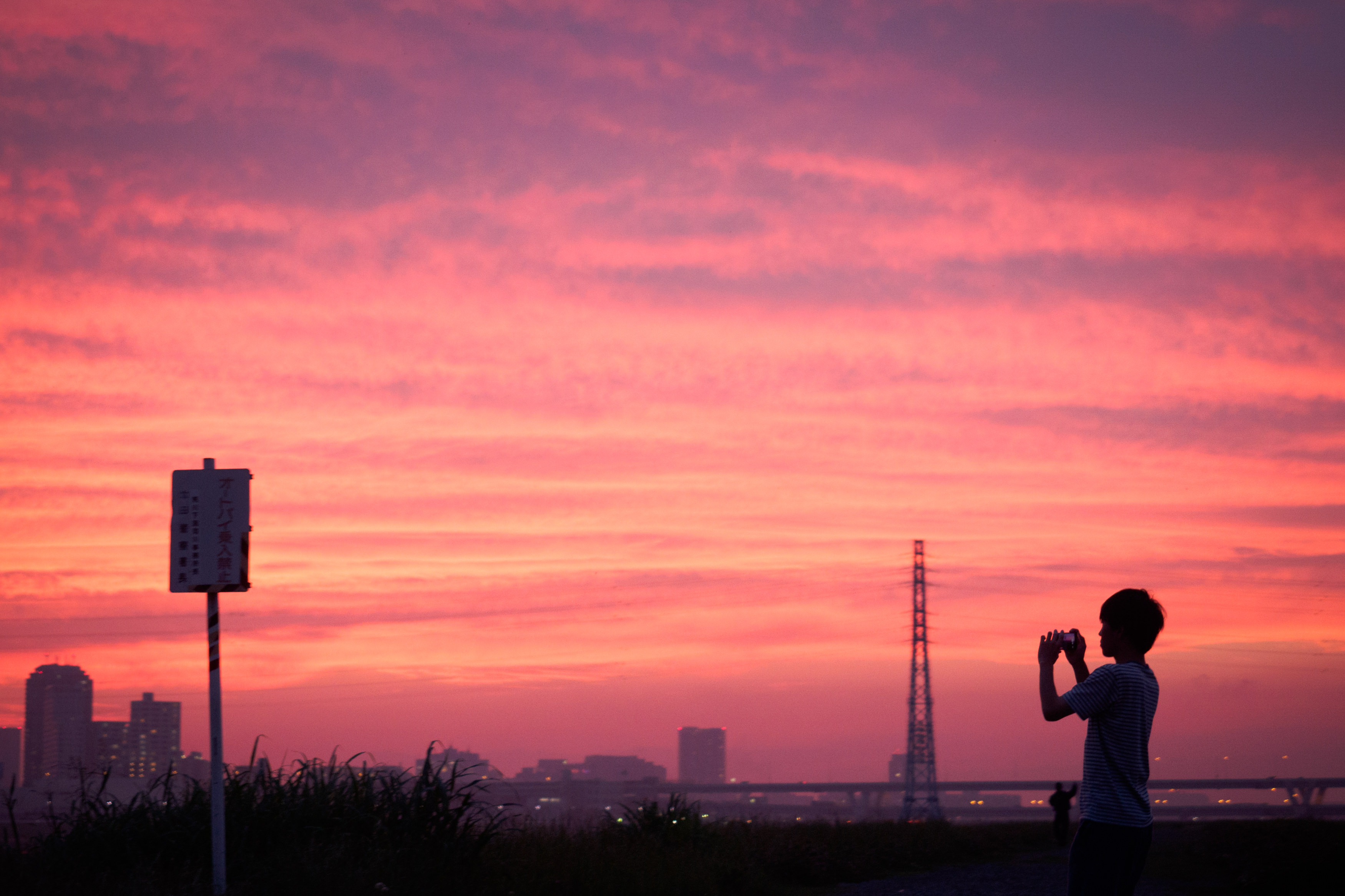 夕焼け空を撮影する少年の写真を無料ダウンロード フリー素材 ぱくたそ