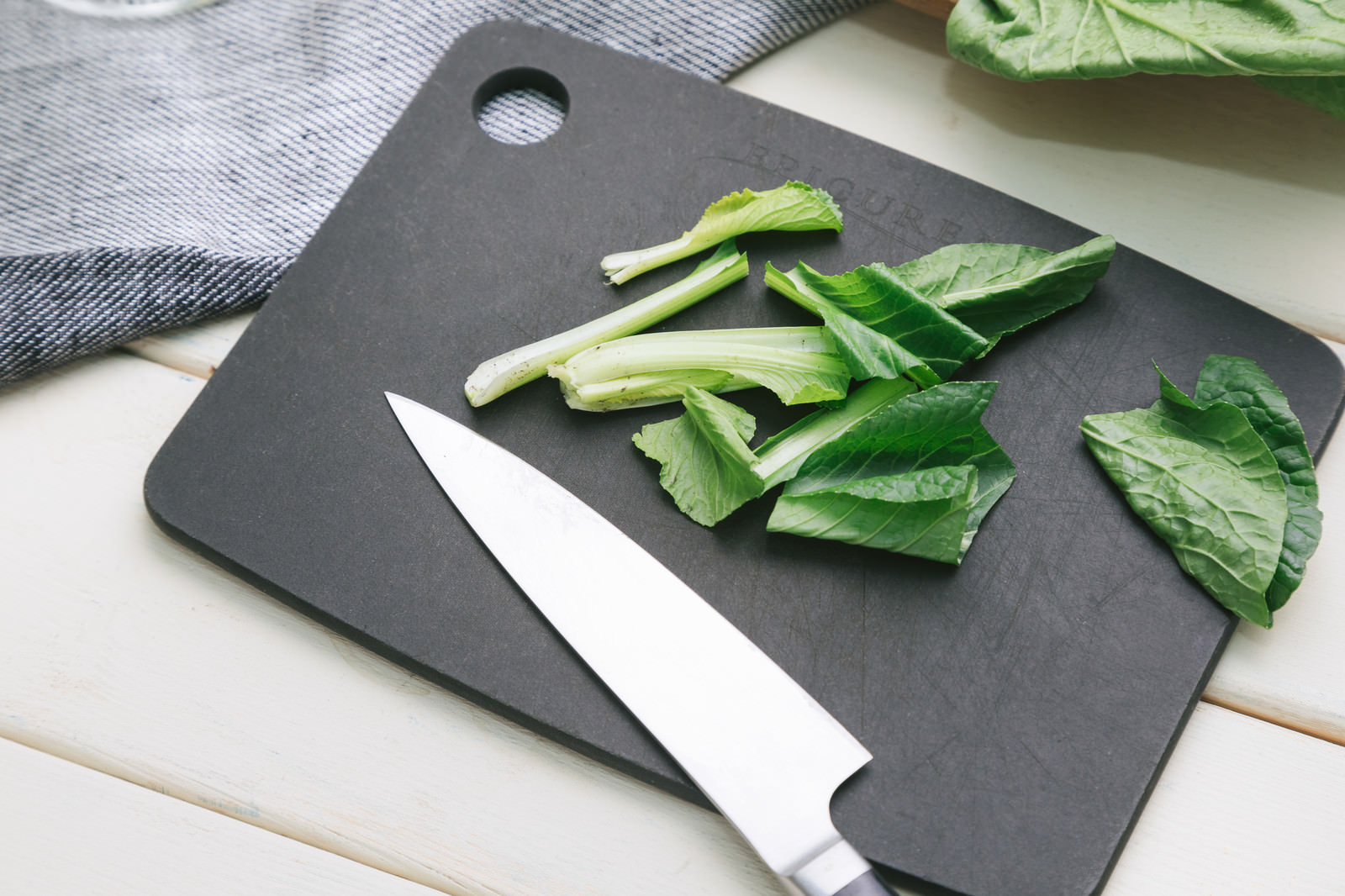 「小松菜を包丁でざく切り」の写真