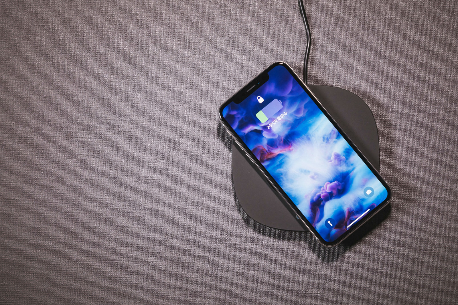 「iPhone X をワイヤレス充電する | フリー素材のぱくたそ」の写真