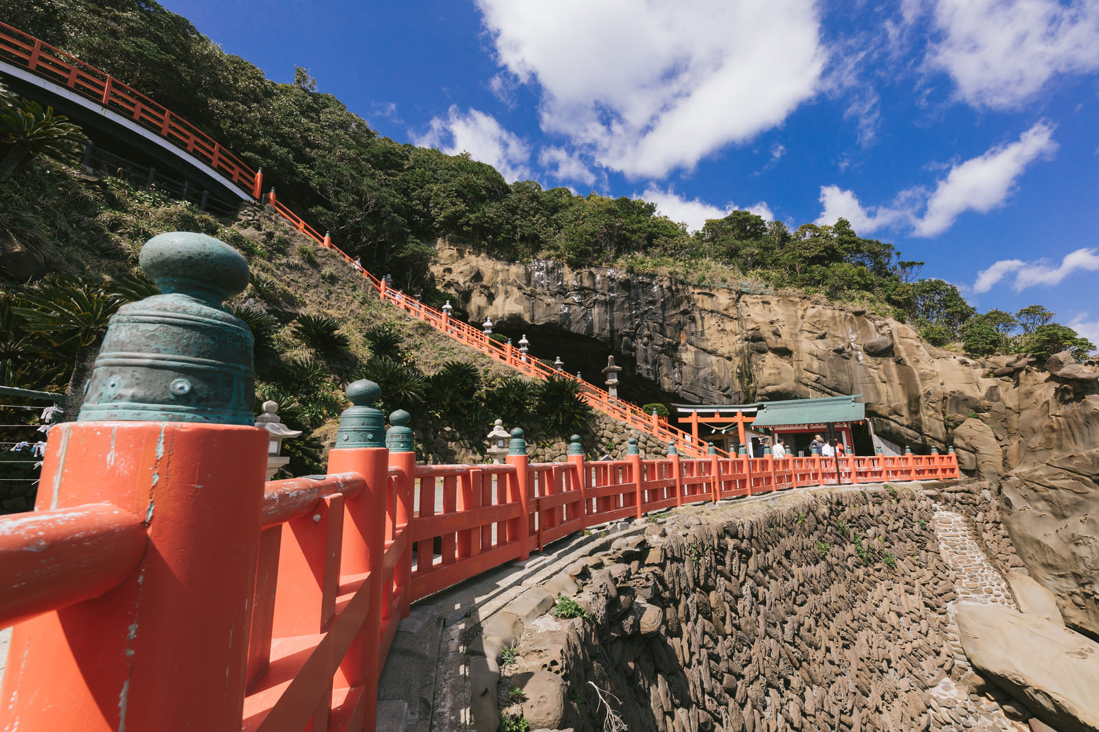 「断崖にある鵜戸神宮と朱塗りの柵（玉垣）」の写真