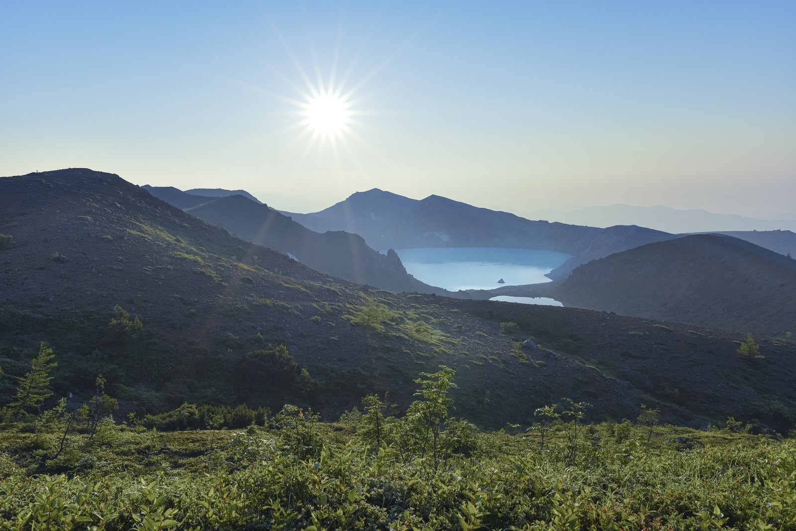 「朝焼けに輝く草津白根山湯釜」の写真