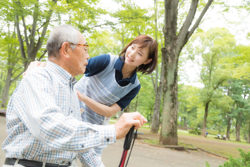 高齢のお爺さんと女性介護士の様子 フリー素材のぱくたそ