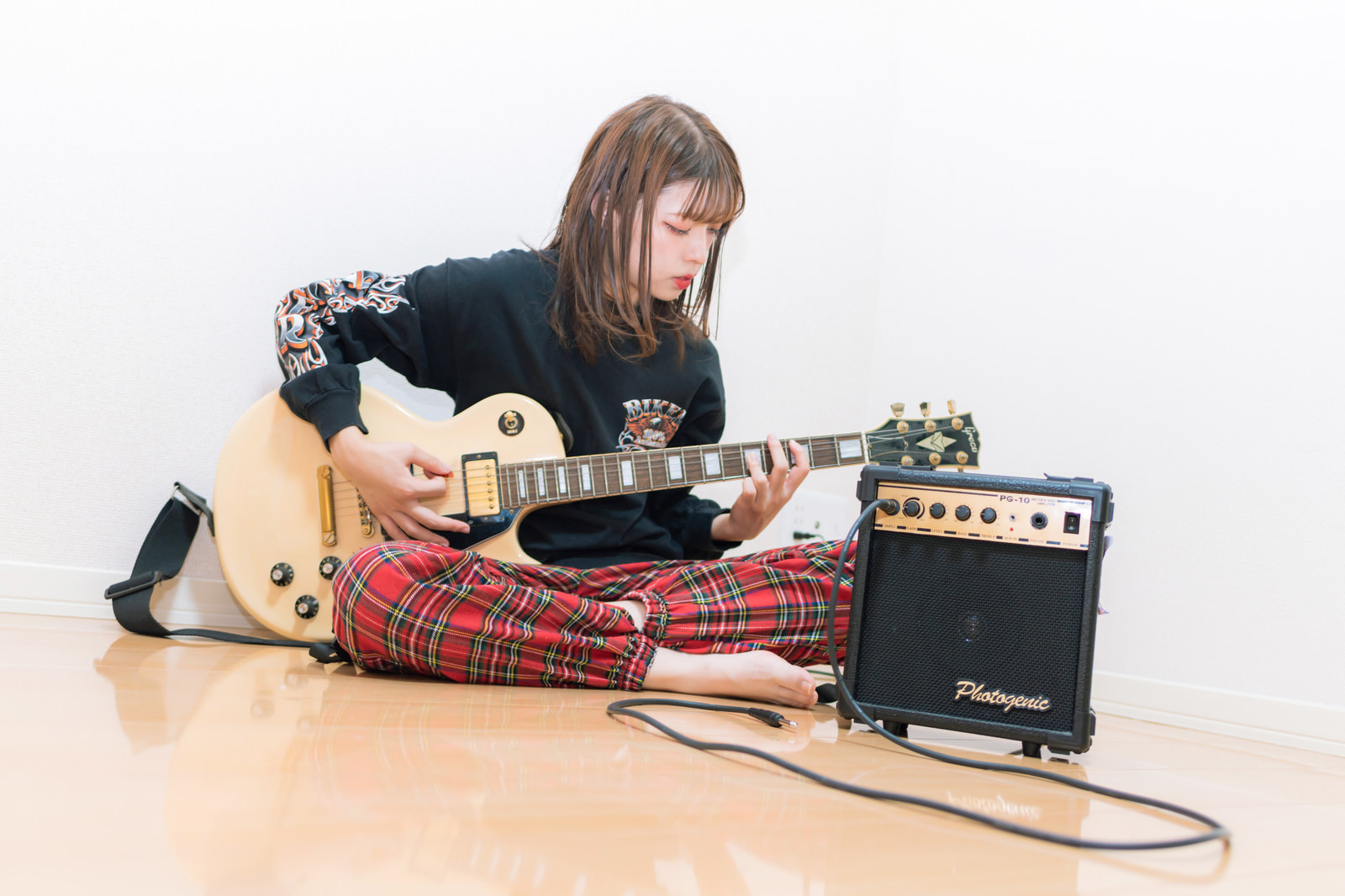 「部屋でギターを練習する彼女」の写真［モデル：高尾実生］